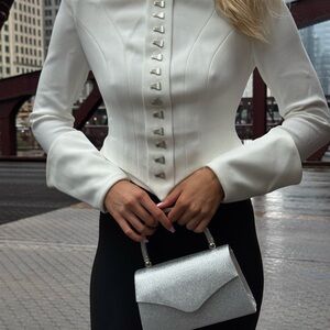 Elegant White Buttoned Jacket with Silver Clutch
